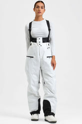 Pantalones de nieve holgados, aislantes y blancos para mujer con tirantes desmontables